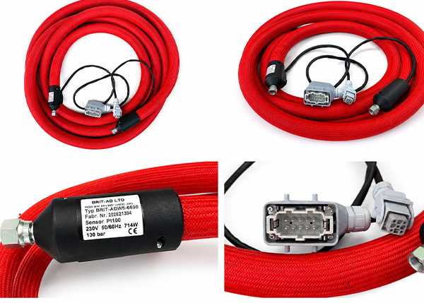 Red industrial hoses with connectors and sensors for hot melt adhesive systems.